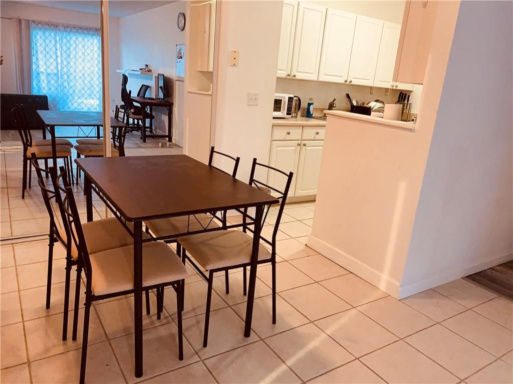 1700 Southwest 16th Court, Unit P6 Gainesville, FL 32608 - Photo 2 of 7 a dining room with furniture and wooden floor