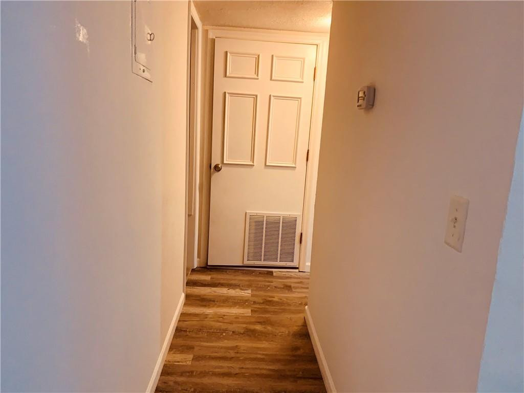 1700 Southwest 16th Court, Unit P6 Gainesville, FL 32608 - Photo 4 of 7 a view of a hallway with wooden floor