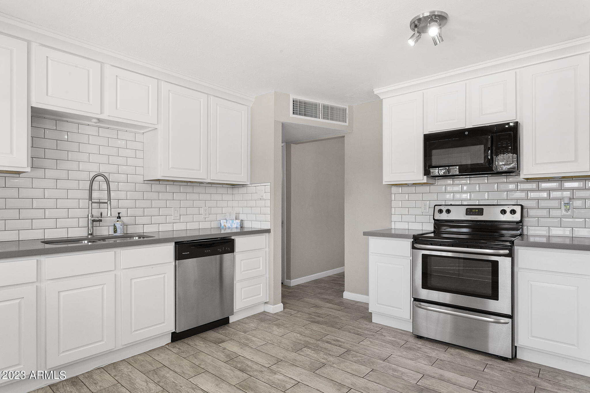 2525 West Freeway Lane Phoenix, AZ 85021 - Photo 11 of 41 a kitchen with granite countertop a sink and steel appliances