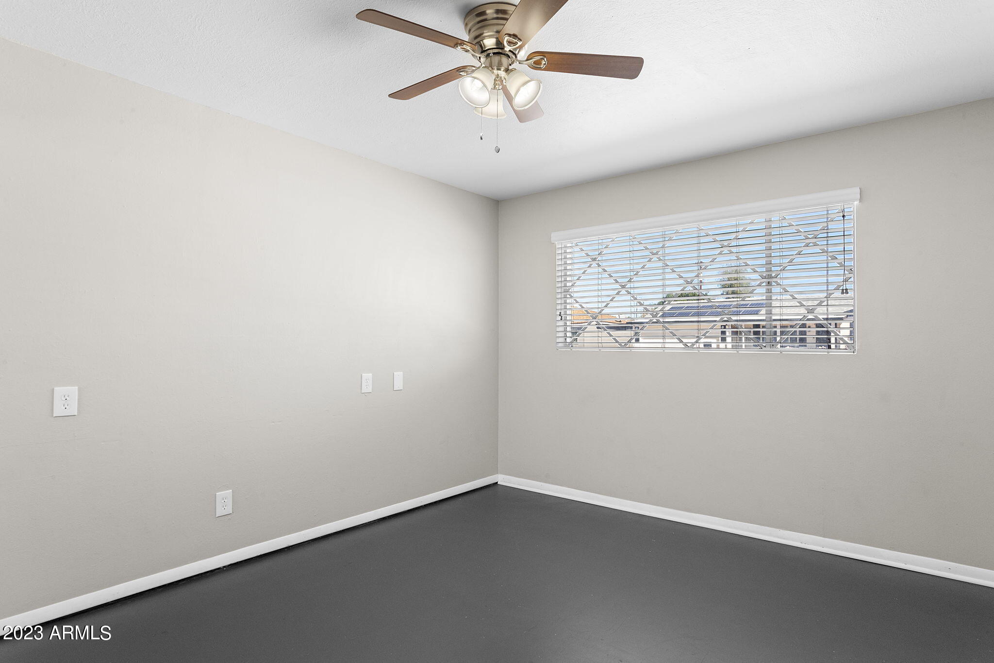 2525 West Freeway Lane Phoenix, AZ 85021 - Photo 22 of 41 an empty room with a window and a ceiling fan
