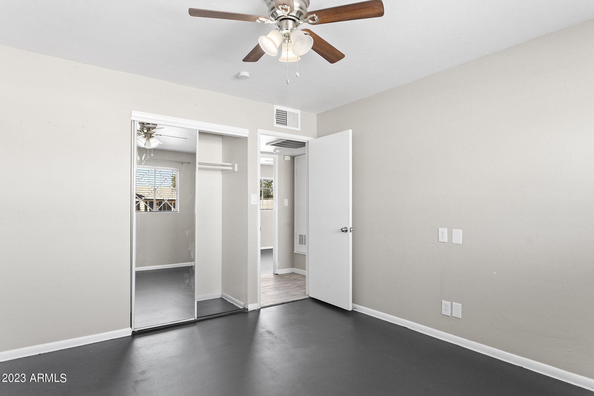 2525 West Freeway Lane Phoenix, AZ 85021 - Photo 25 of 41 an empty room with wooden floor closet and windows