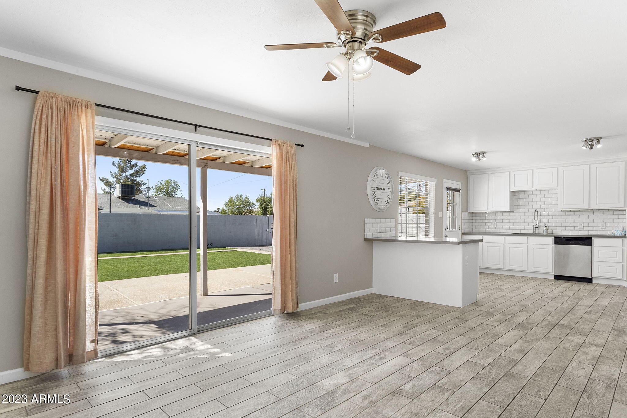 2525 West Freeway Lane Phoenix, AZ 85021 - Photo 7 of 41 a view of a kitchen with wooden floor and a ceiling fan