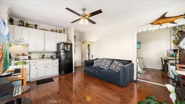 a living room with stainless steel appliances kitchen island granite countertop furniture and a kitchen view