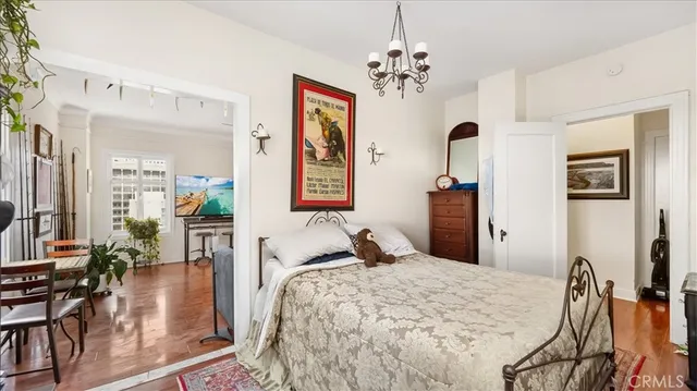 a bedroom with a bed and chandelier