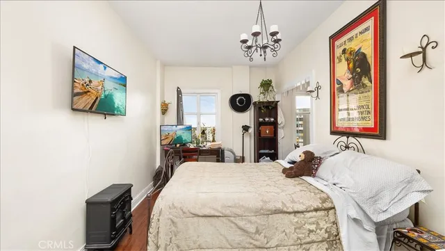 a bedroom with a bed and a chandelier