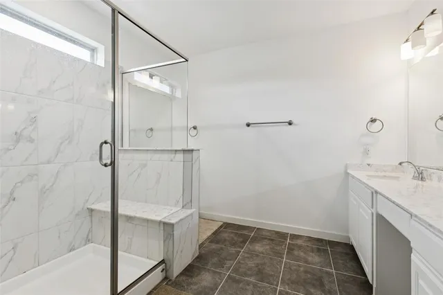 a bathroom with a shower and sink