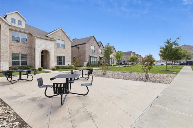 a view of a house with backyard sitting area and garden