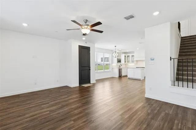 a view of a kitchen with wooden floor and a kitchen
