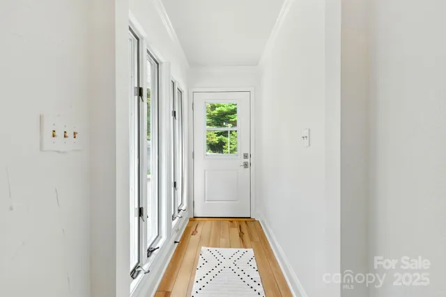 a view of hallway with wooden floor
