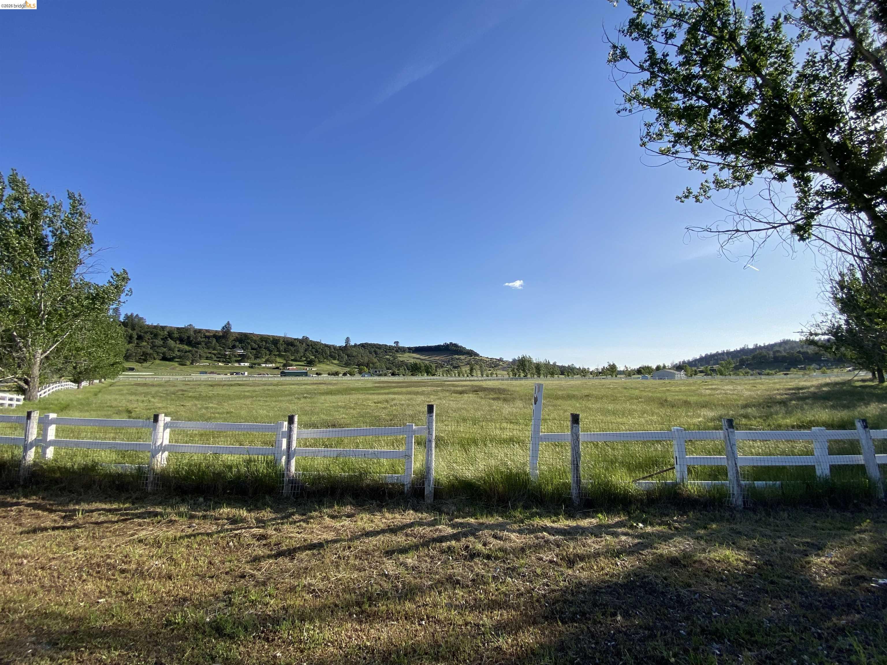 19144 Rawhide Road Jamestown, CA 95327 - Photo 1 of 6 a view of a lake with houses in the background