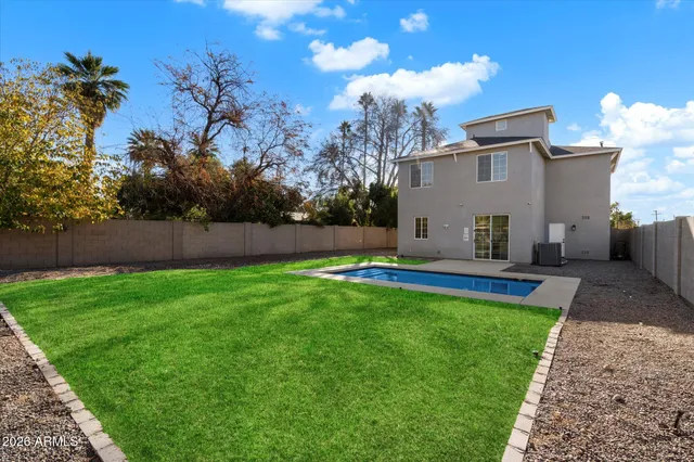 a view of yard with swimming pool and sitting area