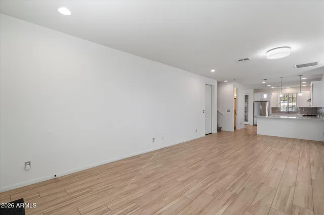 an empty room with wooden floor