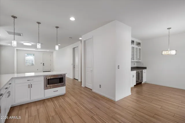 a kitchen with kitchen island granite countertop a stove a sink and a refrigerator