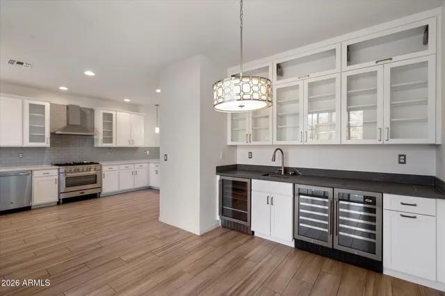 a large kitchen with stainless steel appliances granite countertop a stove and a sink