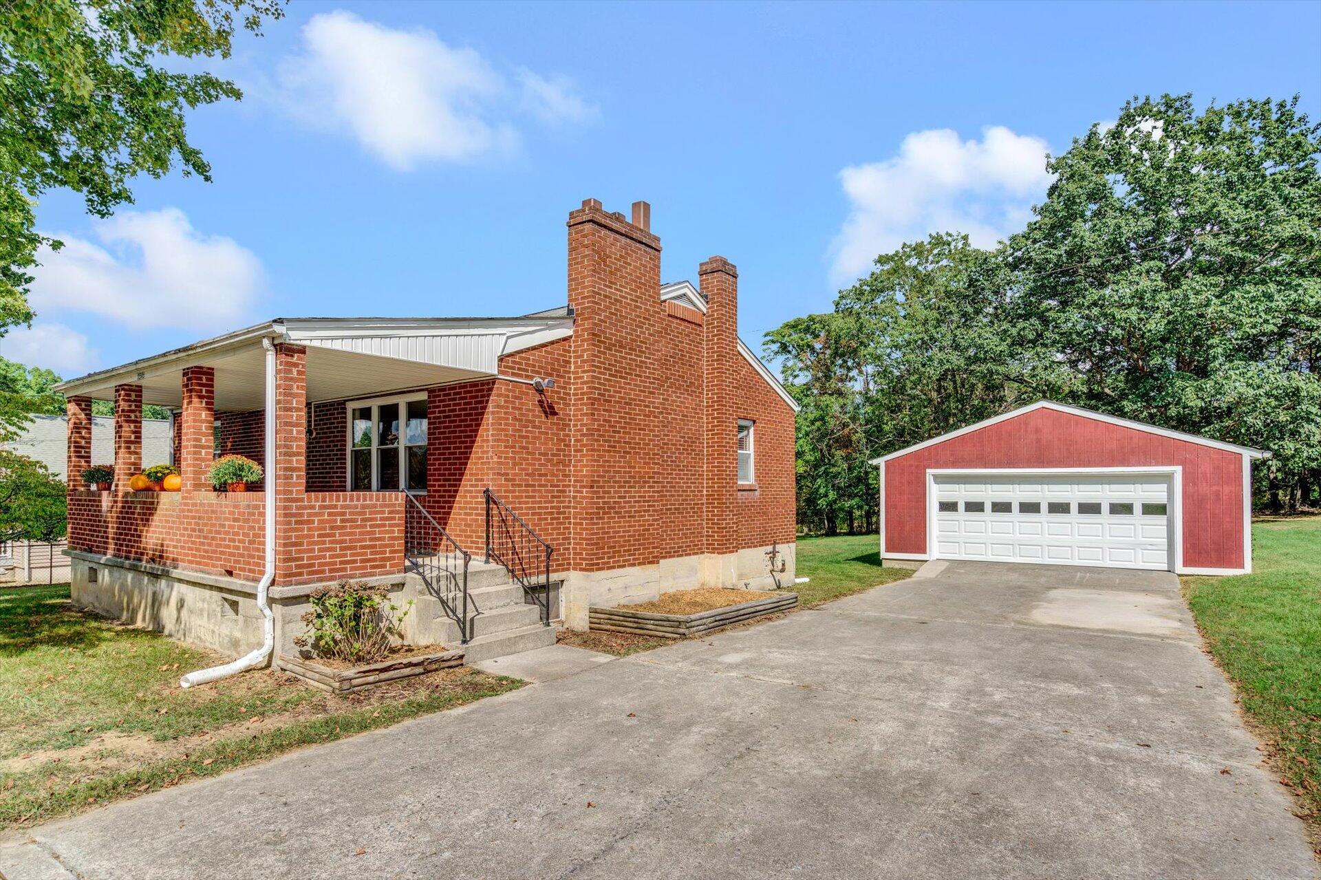 4546 Cowman Road Roanoke, VA 24014 - Photo 1 of 29 a view of small white house with a small yard and large trees