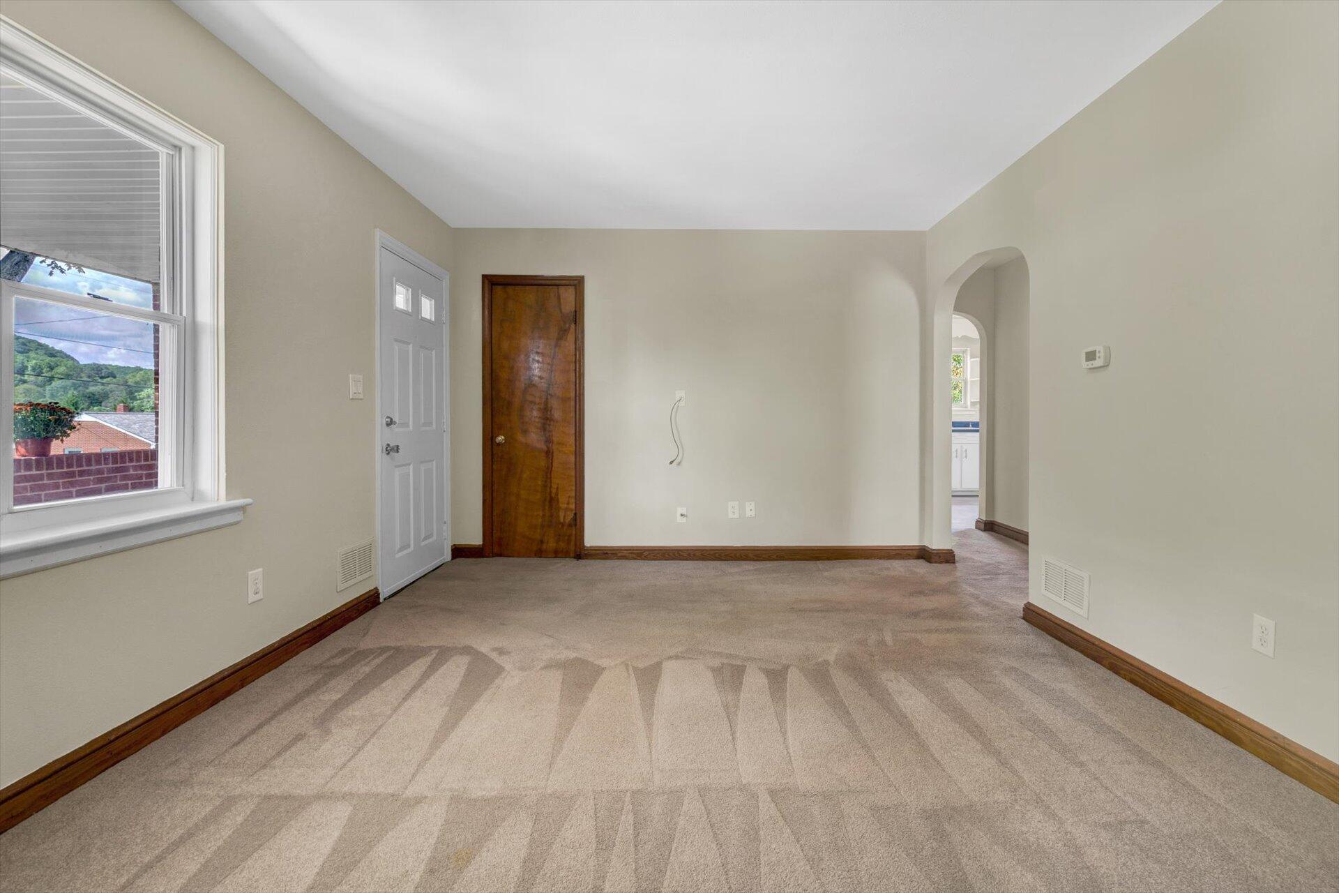 4546 Cowman Road Roanoke, VA 24014 - Photo 9 of 29 a view of an empty room with wooden floor and a window