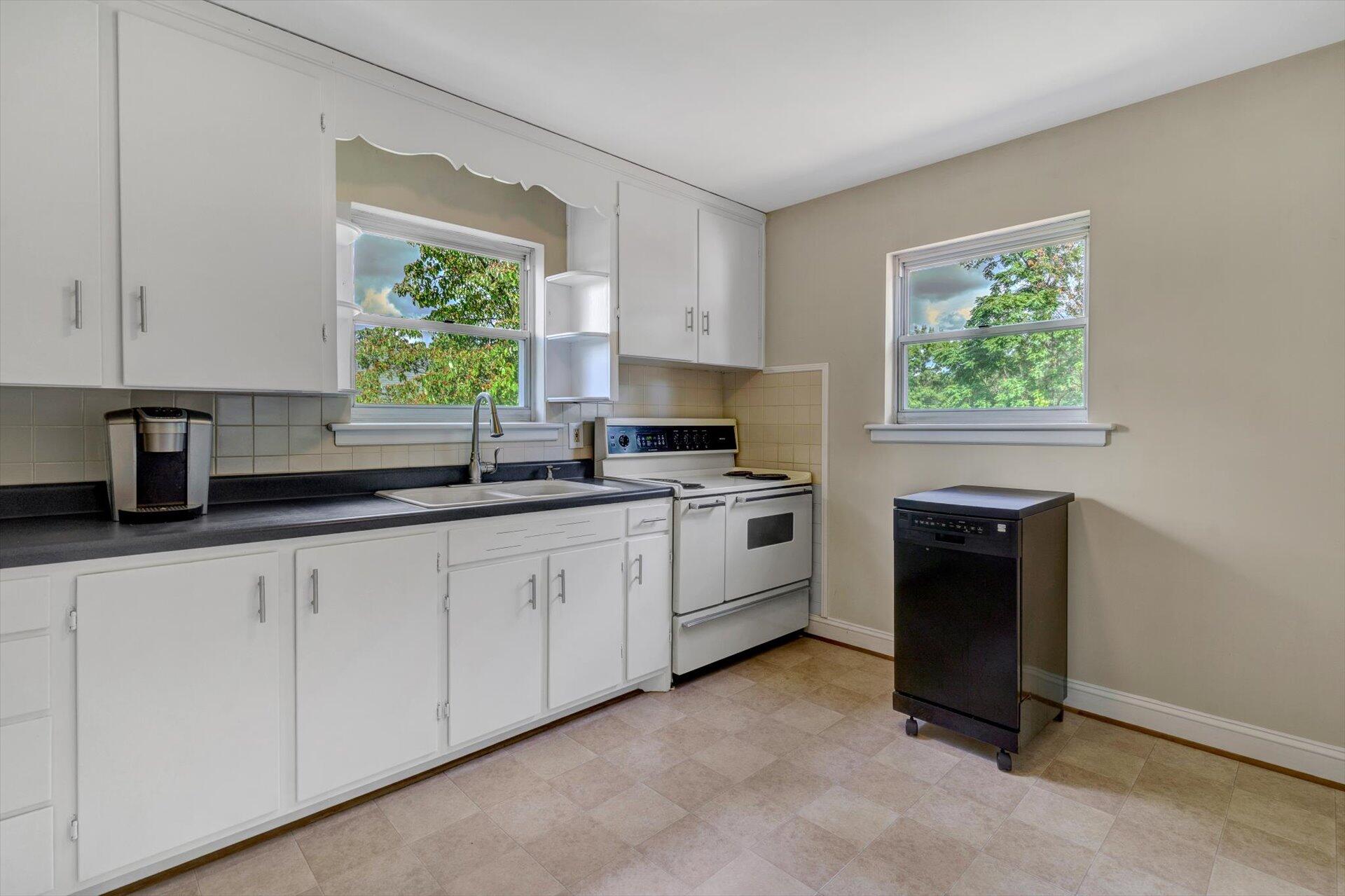 4546 Cowman Road Roanoke, VA 24014 - Photo 10 of 29 a kitchen with granite countertop white cabinets and a window