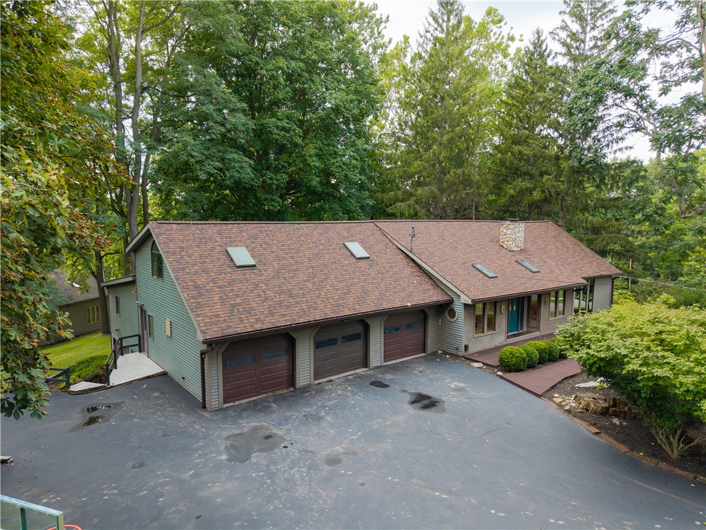 301 Spring Street Avon, NY 14414 - Photo 41 of 50 Freshly sealed driveway, turnaround, basketball hoop, shed & 3 bay attached garage