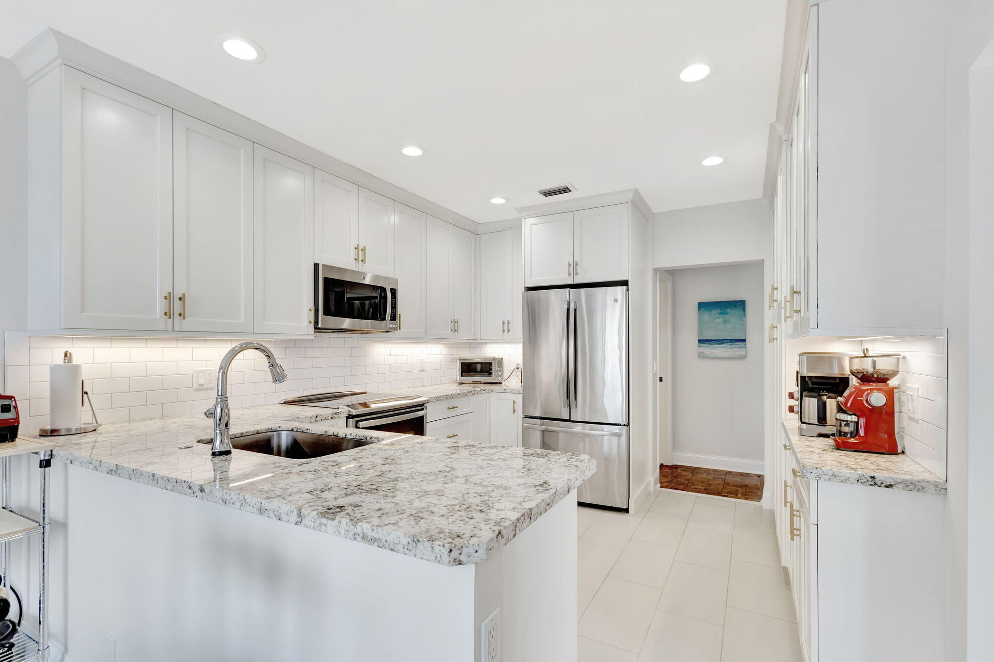 170 Celestial Way, Unit 83 Juno Beach, FL 33408 - Photo 20 of 70 a kitchen with stainless steel appliances granite countertop a refrigerator and a sink