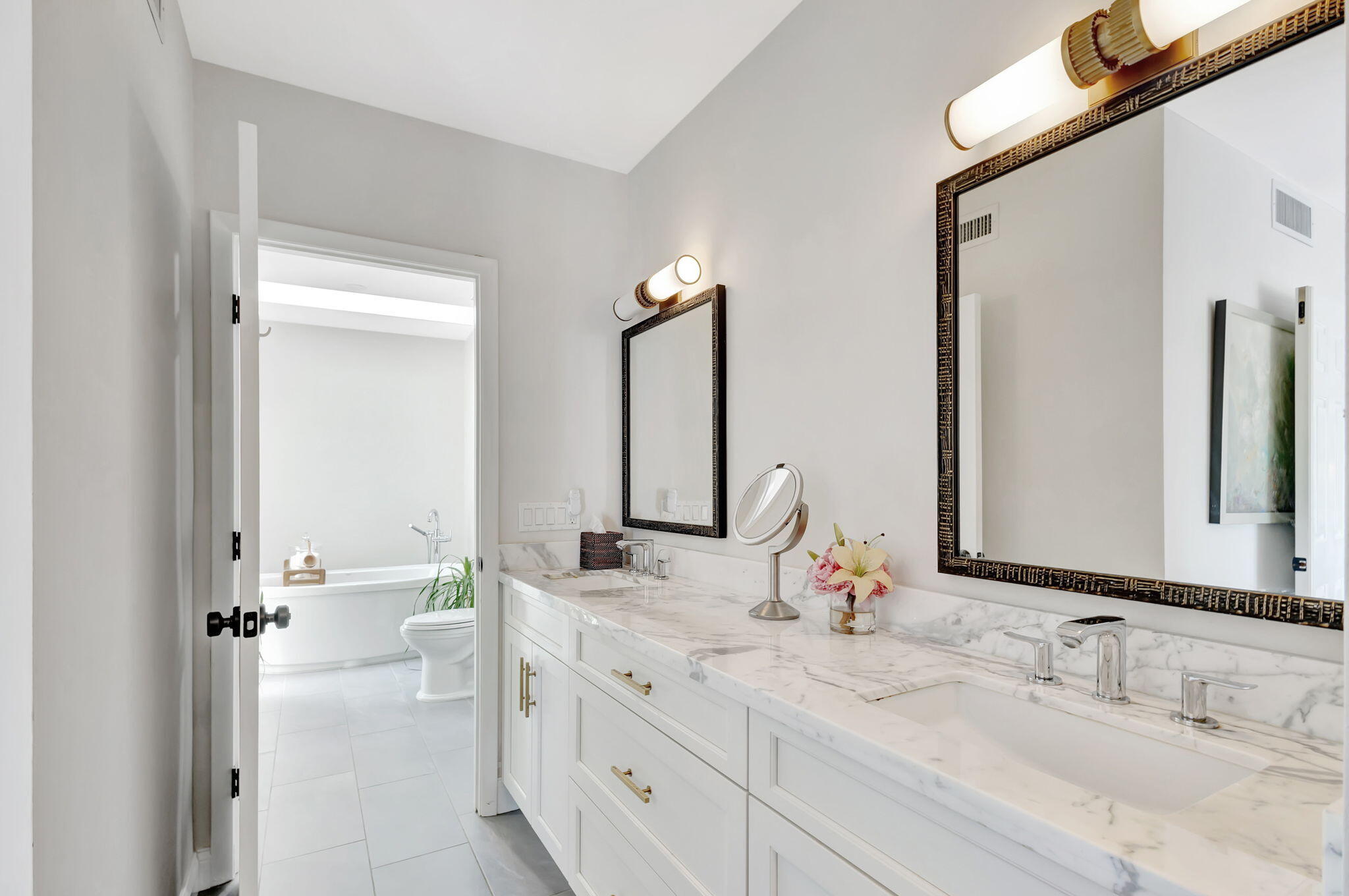 170 Celestial Way, Unit 83 Juno Beach, FL 33408 - Photo 33 of 70 a bathroom with double vanity sinks and a mirror