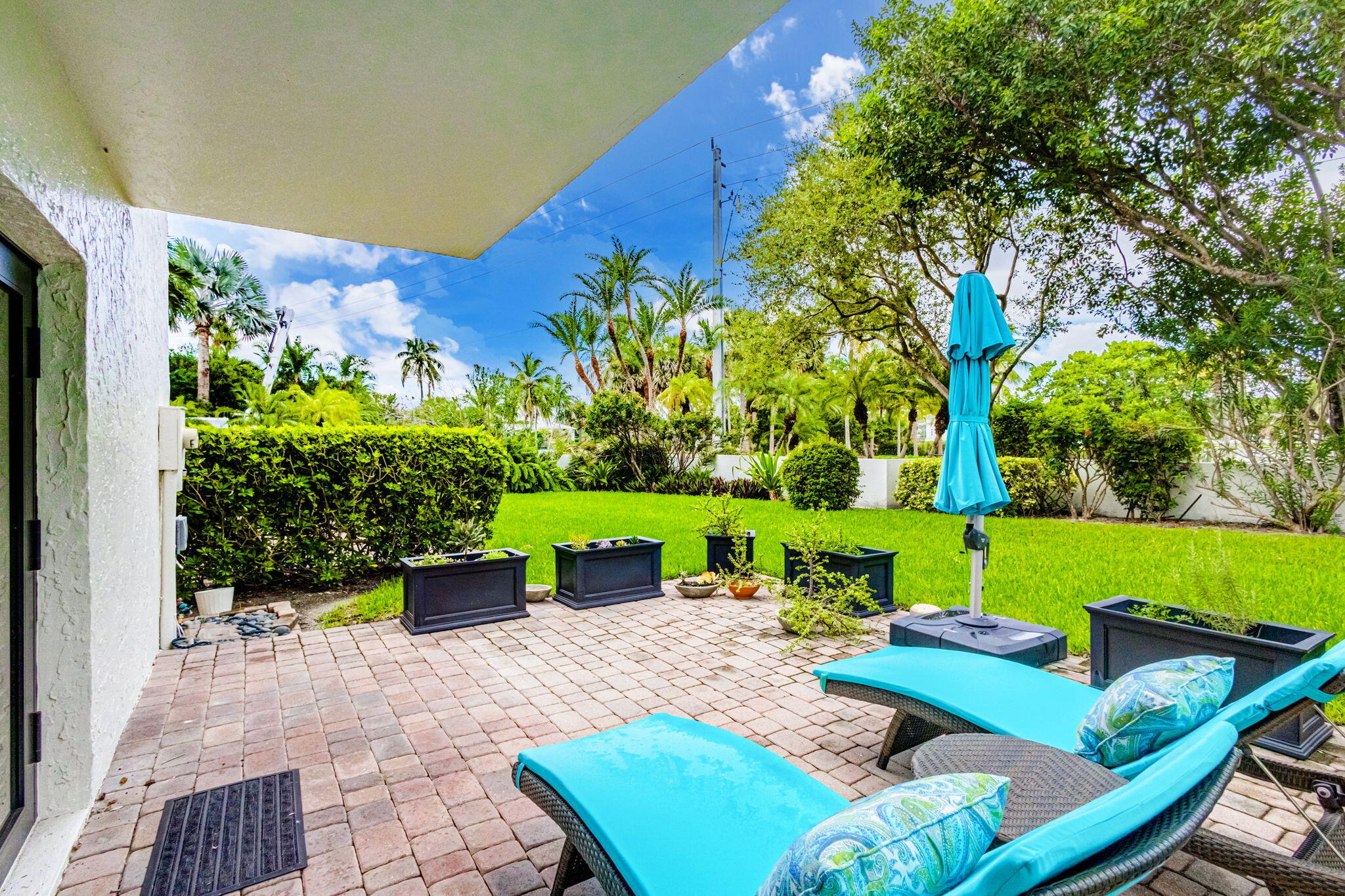 170 Celestial Way, Unit 83 Juno Beach, FL 33408 - Photo 48 of 70 a view of backyard with seating area and green space