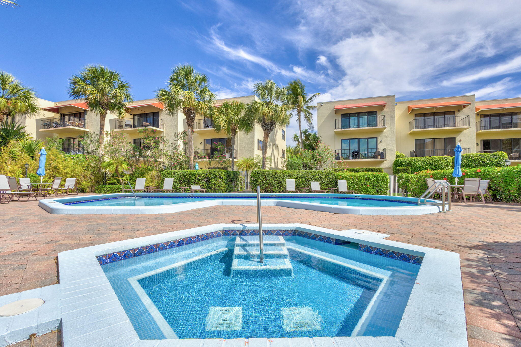 170 Celestial Way, Unit 83 Juno Beach, FL 33408 - Photo 60 of 70 a swimming pool with outdoor seating and yard