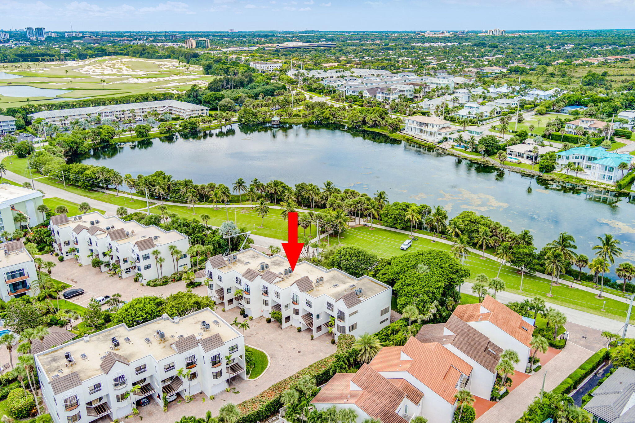 170 Celestial Way, Unit 83 Juno Beach, FL 33408 - Photo 65 of 70 an aerial view of a city with lots of residential buildings ocean and mountain view in back