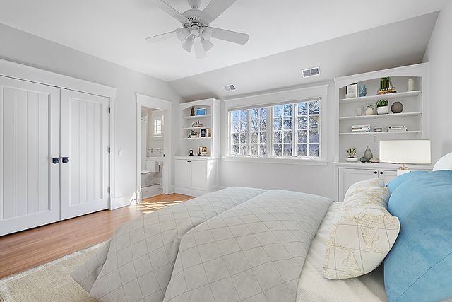 a bedroom with a bed and a book shelf