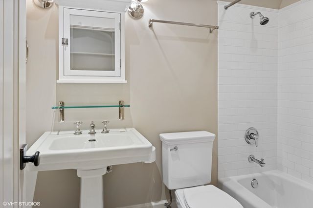 a bathroom with a sink a mirror and a toilet