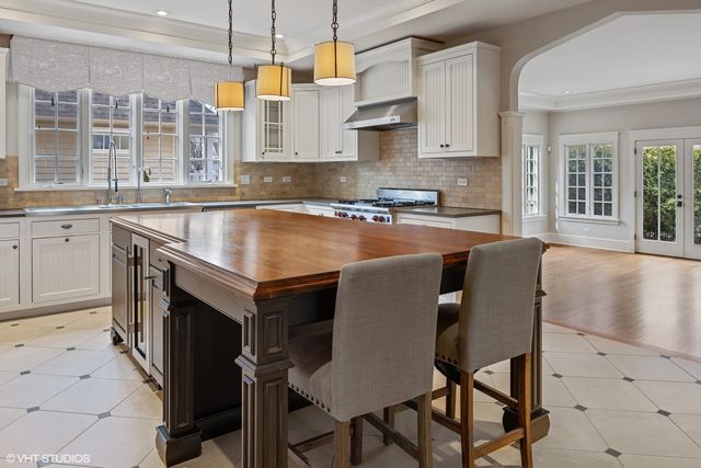 a kitchen with a stove a sink and a refrigerator