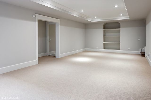 an empty room with windows and entrance