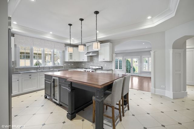 a kitchen with kitchen island granite countertop lots of counter top space and sink