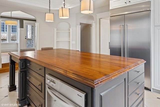 a kitchen with stainless steel appliances granite countertop white cabinets and a sink