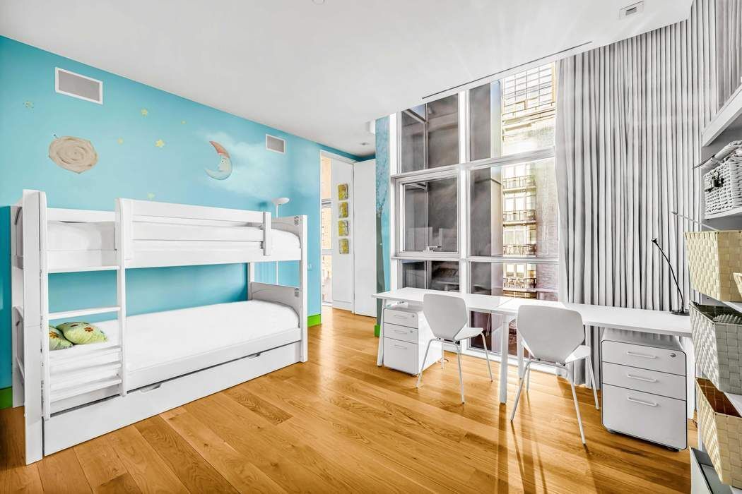 471 Washington Street, Unit 4B Manhattan, NY 10013 - Photo 9 of 11 a bedroom with a bed and a large window