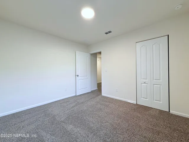 a view of an empty room and entryway