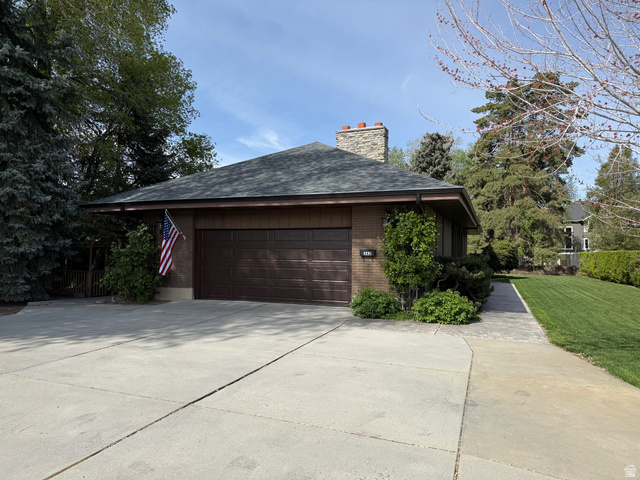 362 East 9150th Street South Sandy, UT 84070 - Photo 1 of 41 View of side of home with brick siding, concrete driveway, a chimney, a garage, and roof with shingles