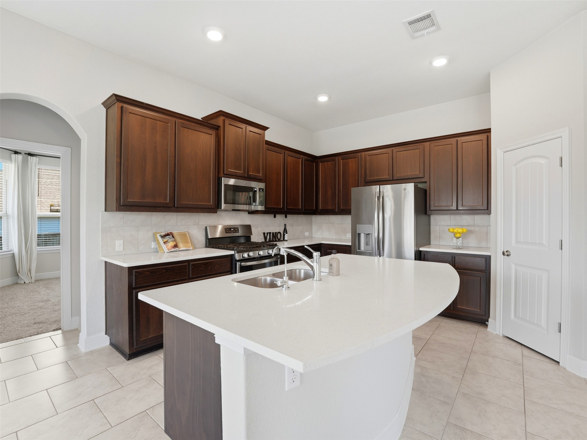 2132 Ringstaff Road Leander, TX 78641 - Photo 15 of 39 Culinary delights await in this bright kitchen with a spacious island and gleaming stainless steel appliances.