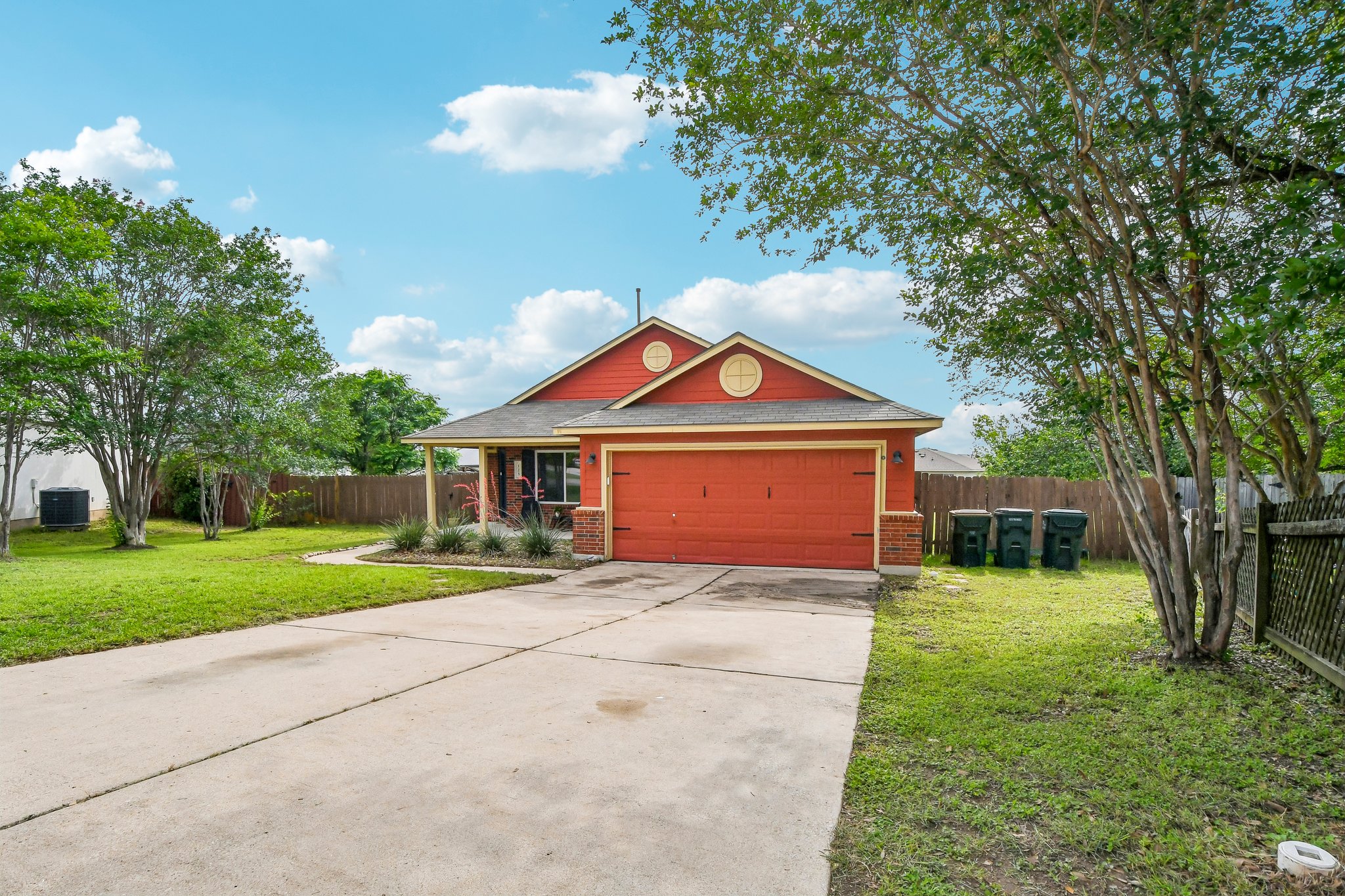 125 Mason Reed Cove Kyle, TX 78640 - Photo 2 of 39 a front view of a house with a yard and garage
