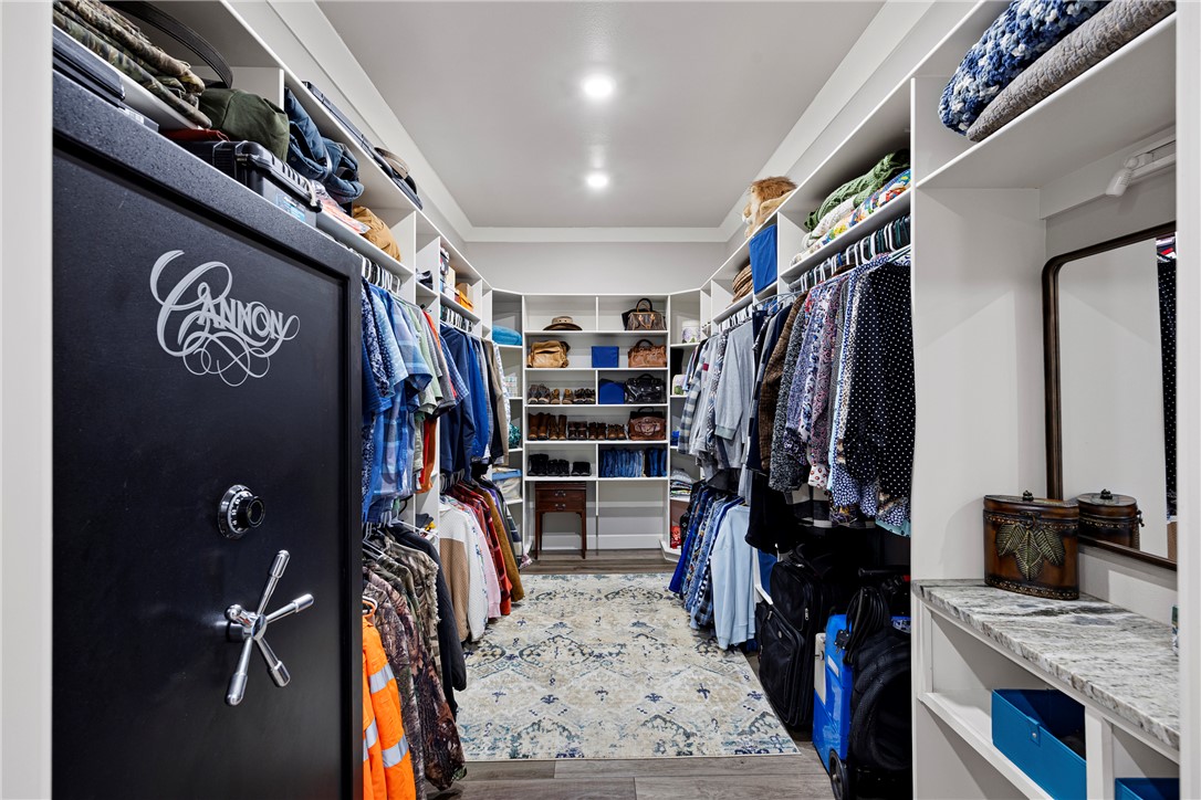3419 Bailey Loop Road London, AR 72847 - Photo 27 of 60 Custom closet system featuring extensive shelving, hanging rods, recessed lighting, and wood-finish flooring