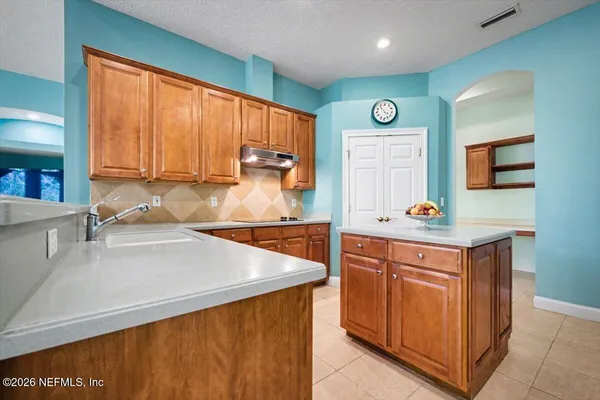 a kitchen with a sink stove and cabinets