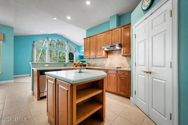 a kitchen with stainless steel appliances a stove microwave and refrigerator