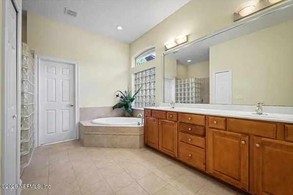a bathroom with a tub shower and sink