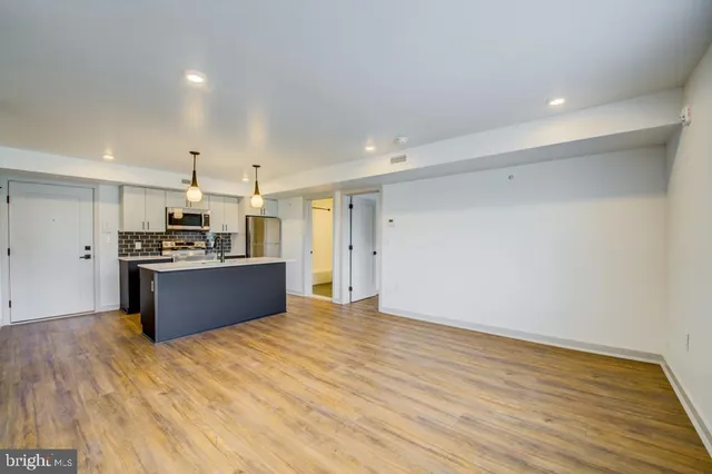 a kitchen with stainless steel appliances kitchen island wooden cabinets and granite counter tops