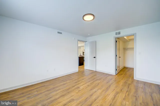 a view of an empty room and wooden floor