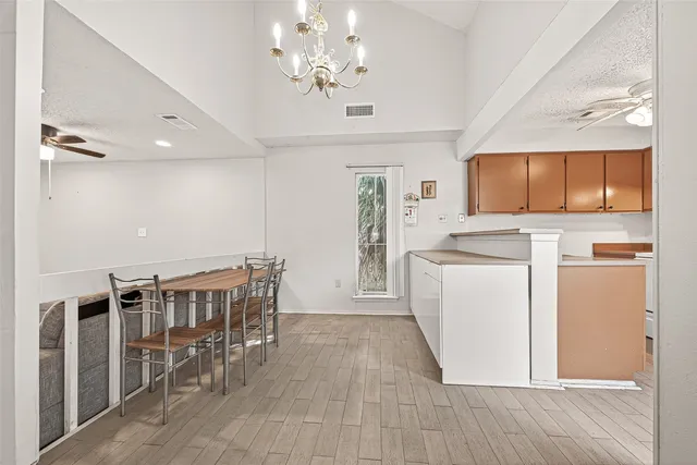 a kitchen with granite countertop a sink a stove and cabinets