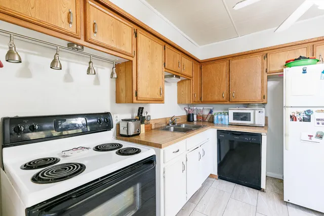 a kitchen with a stove a sink and a refrigerator