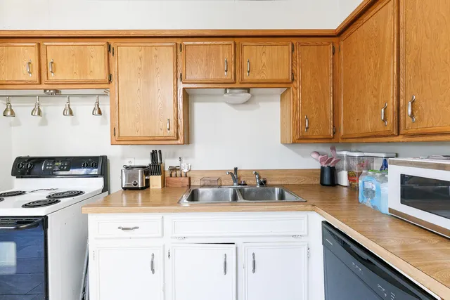 a kitchen with a sink cabinets and appliances