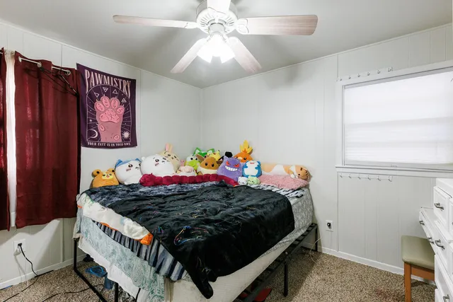 a bed room with a bed and a baby bed