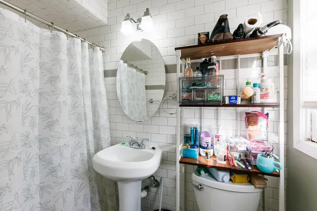 a bathroom with a sink a toilet and shower curtain