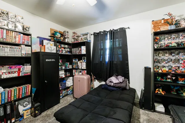 a living room with lots of furniture and a book shelf
